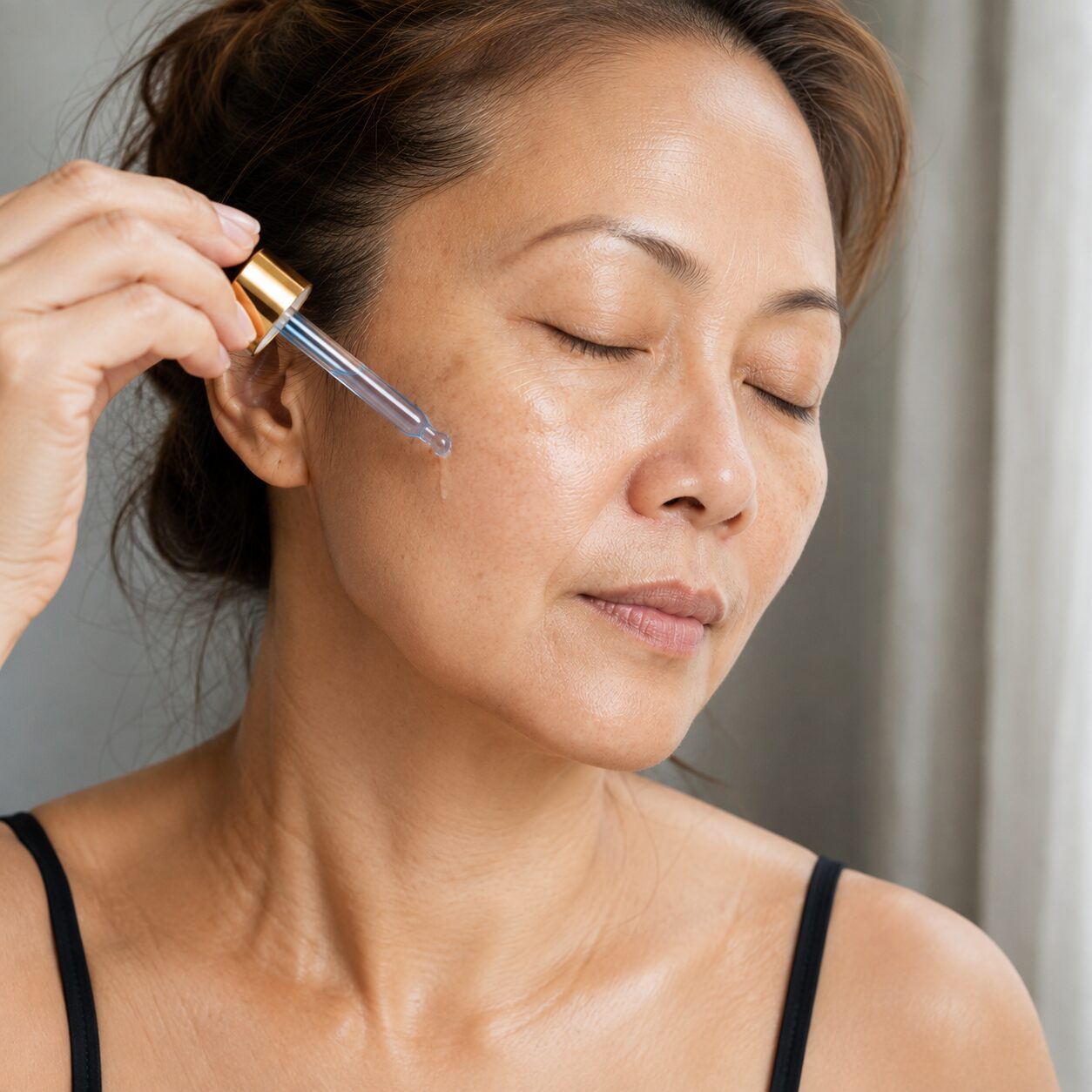 Woman applying serum